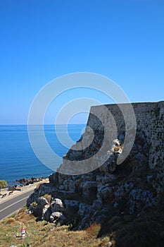 Asphalt road goes along the sea on the island of Crete.