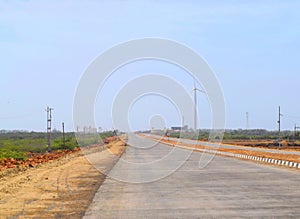 Asphalt Road in India with Roadside Windmill - Straight Highway into Far Distance - Solo Travel and Expedition