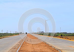 Asphalt Road in India with Roadside Windmill - Straight Highway into Far Distance - Solo Travel and Expedition