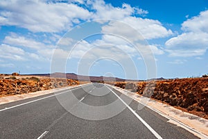 Asphalt road leading to horizon trough the dusty landscape of Boa Vista island.