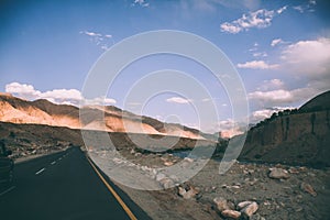 asphalt road and majestic rocky mountains in Indian Himalayas,