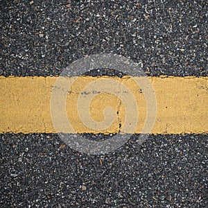 Asphalt road with marking lines. Close-up background texture