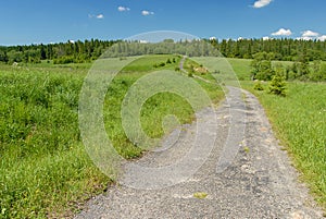 Asphalt road among meadows and forests, Bieszczady Mountains, Poland