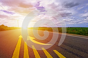 Asphalt road in the morning with sunshine and clould  The road with yellow business candle stick graph chart and arrow of stock