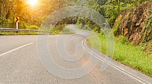 Asphalt road on mountain at colorful sunrise in summer. Road to mountains