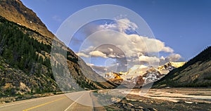 asphalt road in the mountains, near the river with rocks and rocks, coniferous trees