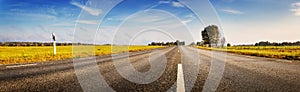 Asphalt road panorama in countryside on sunny autumn day