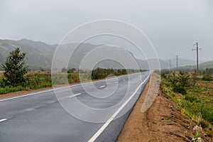 Asphalt road in polar tundra landscape.