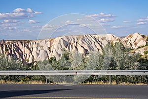 Asphalt road with road markings and mountain landscape of Cappadocia Turkey.