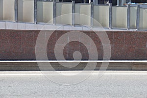 Asphalt road with road markings and a smooth curb, minimalism, gray background.