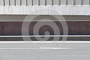Asphalt road with road markings and a smooth curb, minimalism, gray background.