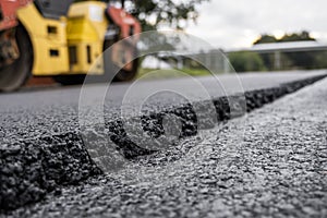 Asphalt road roller with heavy vibration roller compactor press new hot asphalt on the roadway on a road construction