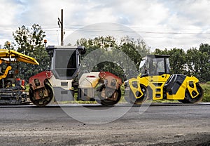 Asphalt road roller with heavy vibration roller compactor press new hot asphalt on the roadway on a road construction