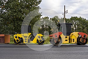 Asphalt road roller with heavy vibration roller compactor press new hot asphalt on the roadway on a road construction