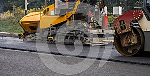 Asphalt road roller with heavy vibration roller compactor press new hot asphalt on the roadway on a road construction