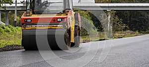 Asphalt road roller with heavy vibration roller compactor press new hot asphalt on the roadway on a road construction