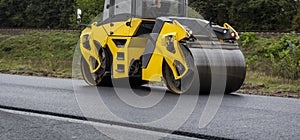 Asphalt road roller with heavy vibration roller compactor press new hot asphalt on the roadway on a road construction