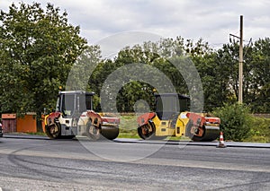 Asphalt road roller with heavy vibration roller compactor press new hot asphalt on the roadway on a road construction