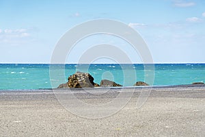 Asphalt road and sea coast line with blue sky on horizon. Landscape in sunny summer day