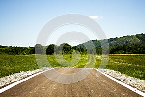 Asphalt road suddenly ending in the middle of nowhere