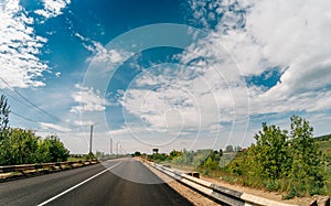 Asphalt road among summer nature landscape, travel journey concept