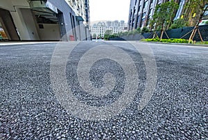 Asphalt road surface with cityscape background, closeup of photo