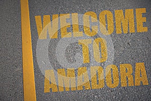 asphalt road with text welcome to Amadora near yellow line