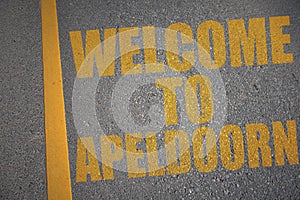asphalt road with text welcome to Apeldoorn near yellow line