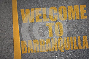 asphalt road with text welcome to Barranquilla near yellow line