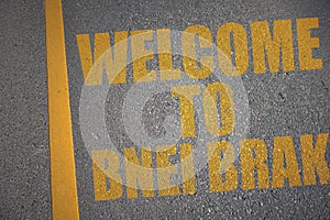 asphalt road with text welcome to Bnei Brak near yellow line