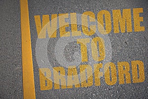 asphalt road with text welcome to Bradford near yellow line