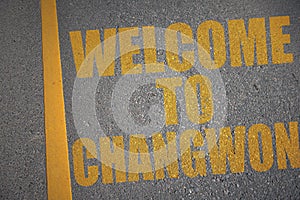 asphalt road with text welcome to Changwon near yellow line