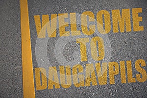 asphalt road with text welcome to Daugavpils near yellow line