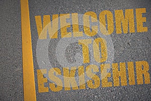 asphalt road with text welcome to Eskisehir near yellow line