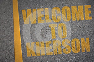 asphalt road with text welcome to Kherson near yellow line