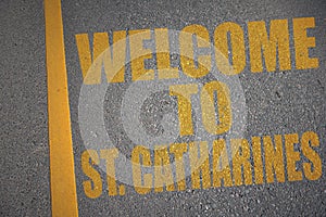 asphalt road with text welcome to St. Catharines near yellow line