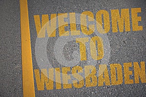 asphalt road with text welcome to Wiesbaden near yellow line
