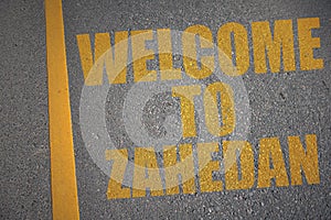 asphalt road with text welcome to Zahedan near yellow line photo