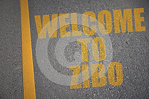 asphalt road with text welcome to zibo near yellow line