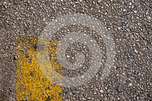 Asphalt road texture with worn yellow paint