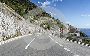 Asphalt road to the sea. Asphalt highway in a sunny day.