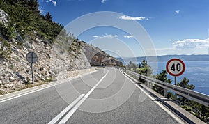 Asphalt road to the sea. Asphalt highway in a sunny day.