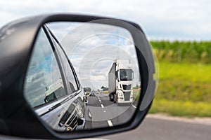 Truck reflected in car mirror