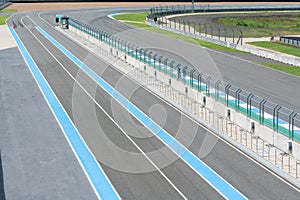 Asphalt road Vehicle track with fence in outdoor circuit, Race track with curve road for car racing.