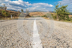 Asphalt road with white dividing strip