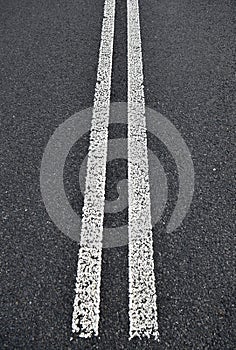 Asphalt road with white double