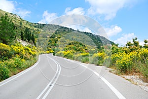 Asphalt road winding through hills