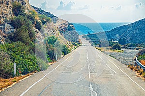 Asphalt seaside road among hills leading to Mediterranean sea