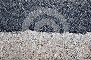 Asphalt street road beside concrete footpath texture background.