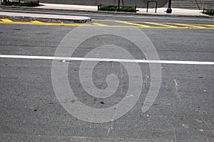 Asphalt street with traffic island and formed curbs, copy space